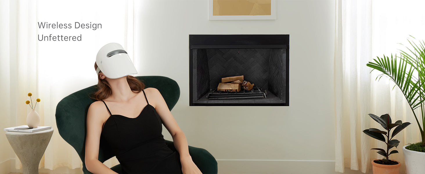 Woman relaxing in a modern home setting using the GYH Cloud-S Wireless LED Light Therapy Mask, highlighting the unfettered design and ease of use.